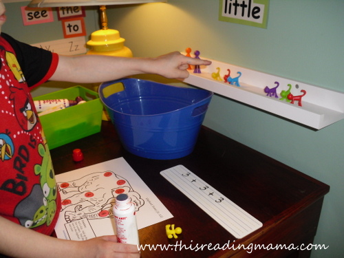 photo of using manipulatives to add and stamp numbers