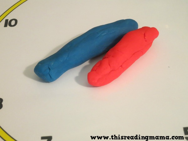 rolling the hands on the clock with playdough