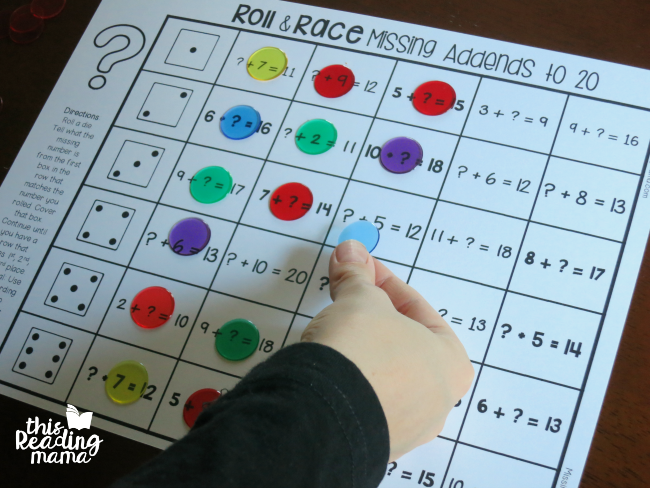 covering addition and subtraction game board with counter